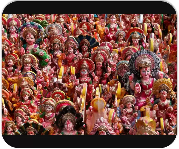 Idols of Hindu Goddess Dashama, left by devotees, are pictured on the banks of river