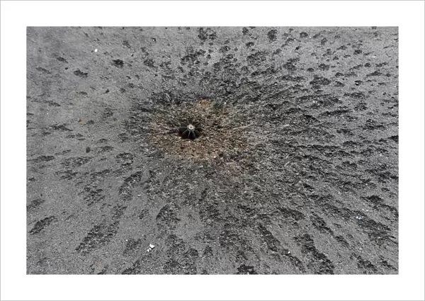 Piece of a mortar projectile is pictured on a road near the airport in Donetsk