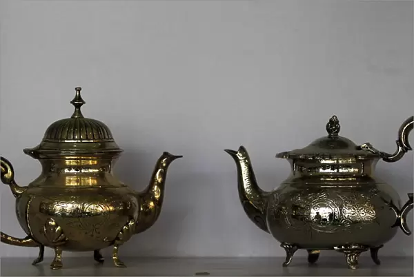Silver plated teapots are seen for sale at an antique store in Islamabad