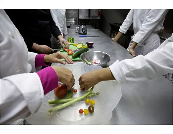 Students take a vegetarian cooking class with Chef Jesus Serrano at the Institute of