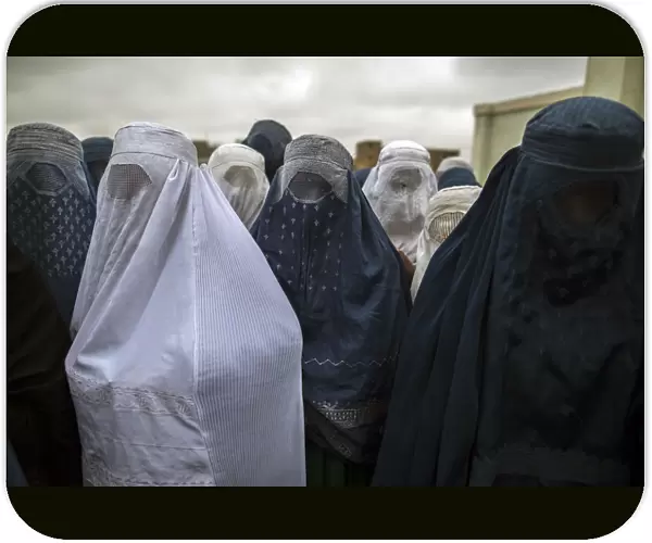 Afghan women wait to cast their ballots at a polling station in Mazar-i-Sharif