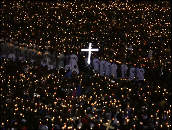 Pilgrims attend a candlelight vigil at the Catholic shrine of Fatima