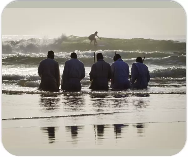 Members of the Shembe Church pray while kneeling in water on the Durban beach front