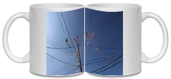 Color ribbon are seen on overhead power lines after firecrackers were set off during