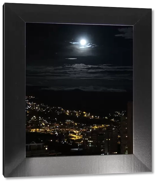 The moon is seen over La Paz city