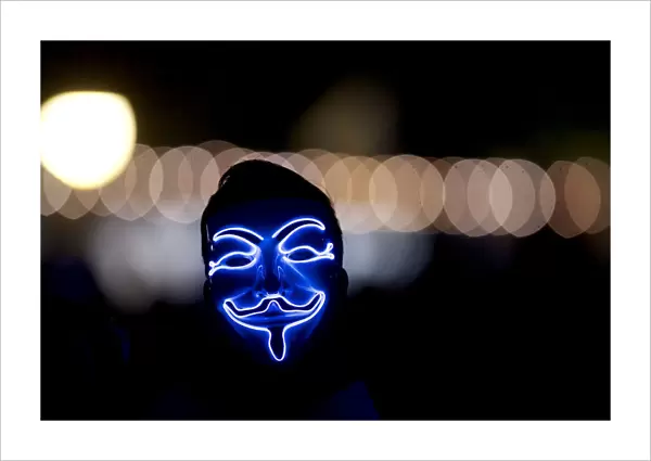 A man wears an anonymous mask on the fourth and final day of the Firefly Music Festival