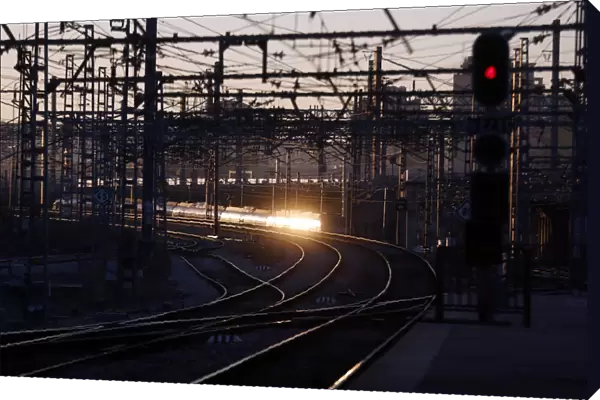 The rising sun reflects on a departing train during a 24-hour nationwide train strike