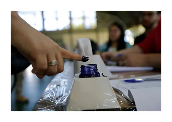 A woman inks his finger before casting her vote during elections in Asuncion