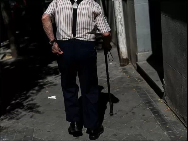 A pensioner goes for a walk in Madrid