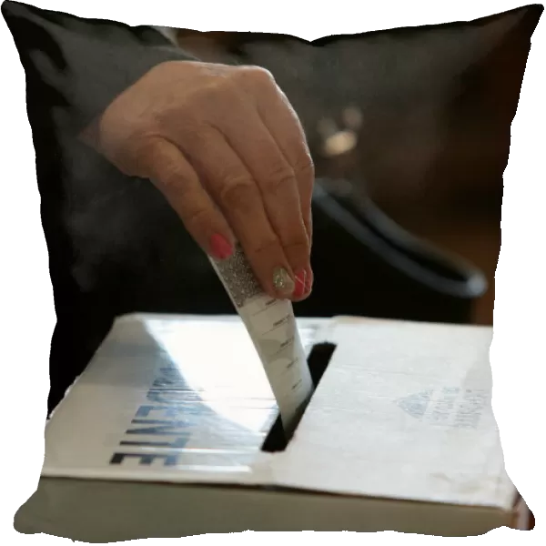 A voter casts her ballot during the presidential election at a polling station in San