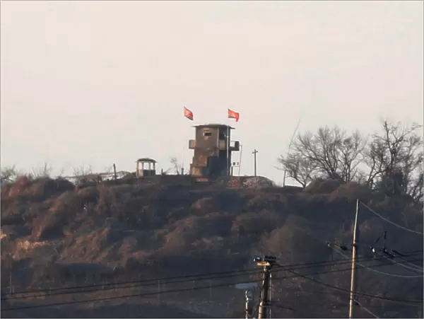 A North Korean flag flutters on the top of their guard post inside North Korean territory