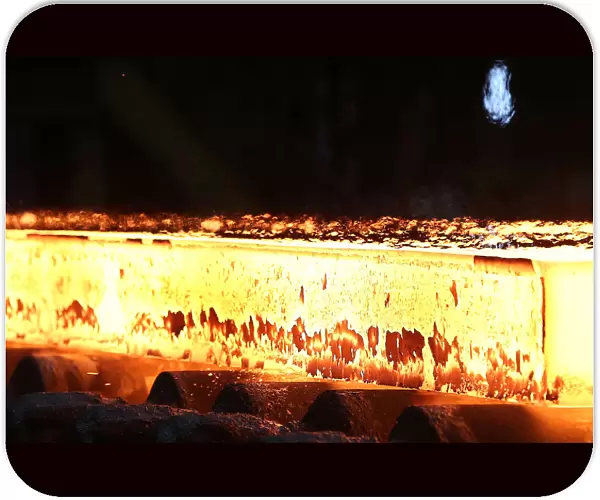 A slab of steel rolls down the line at the Novolipetsk Steel PAO steel mill in Farrell