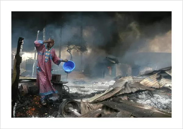 A man rinses soot from his face, Lagos 2006