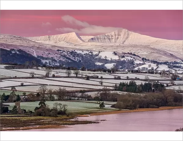 View of snow covered farmland and hills at sunrise, looking from Mynydd Llangorse, Llangorse Lake, Brecon Beacons N. P
