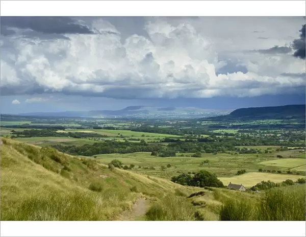 View across farmland towards distant fells, looking towards Clitheroe and Pendle Hill from Parlick Fell, near Chipping