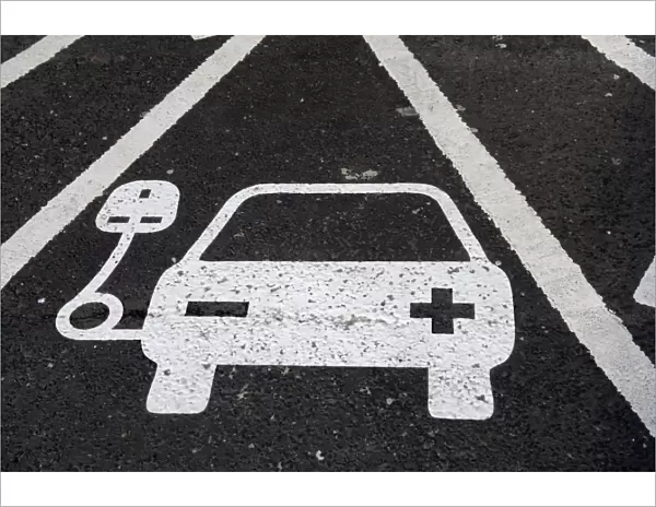 Reserved parking bay at recharging point for electric cars at motorway service area, England, April