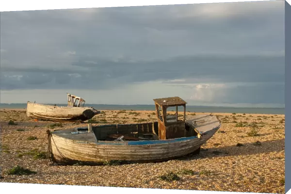 Abandoned fishing boats on shingle beach, Dungeness, Kent, England, April
