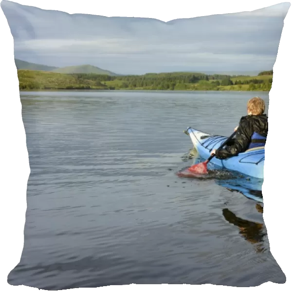 Boy kayaking on reservoir, Killington Lake, Killington Beck, Cumbria, England, June