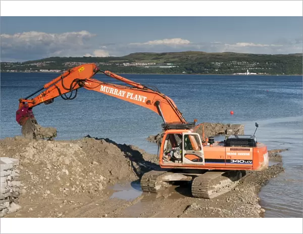 Excavator building sea defences, Dunoon, Firth of Clyde, Argyll and Bute, Scotland, august