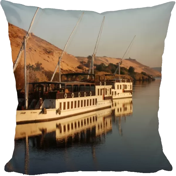Dahabiya passenger boats moored at riverbank, River Nile, Aswan, Egypt, january