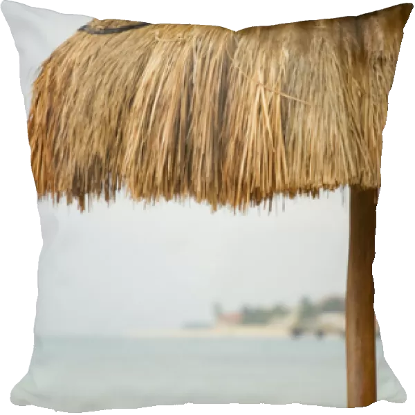 North America, Mexico, Quintana Roo, Playa de Carmen. The roof of a palm hut on a beach