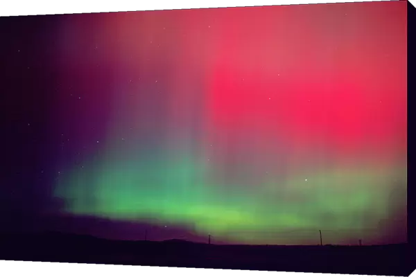 Aurora borealis, northern lights at midnight east of Boise, Idaho following an unusually