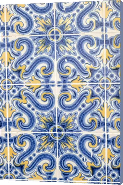 Portugal, Lisbon. Door way with blue and yellow tile work (Azulejos) in the historic