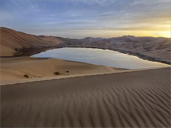 China, Inner Mongolia, Badan Jilin Desert. Sunrise on desert and lake. Credit as