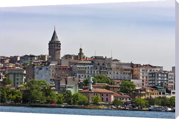 Galata Tower and houses along the waterfront. Golden Horn, Istanbul, Turkey