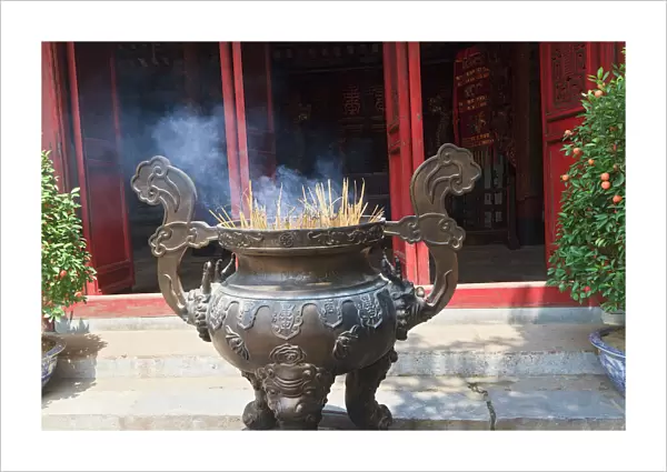 Hanoi, Vietnam. Incense offering at Ngoc Son Pagoda (Temple of the Jade Mound), a