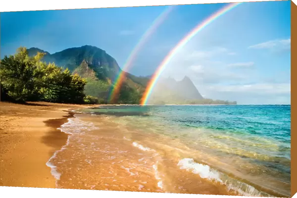 A double rainbow over the coastline of a Hawaiian island with mountains