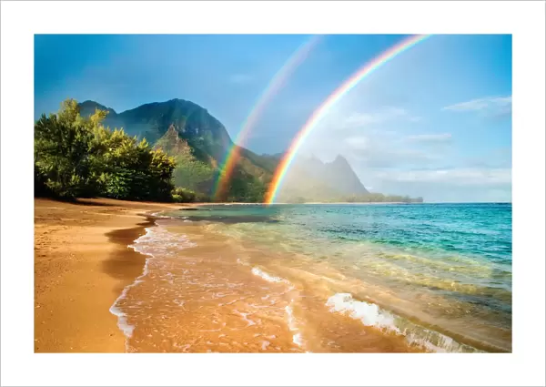 A double rainbow over the coastline of a Hawaiian island with mountains