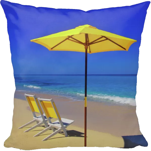 Yellow beach umbrella and chairs on pristine beach, Bimini Island, Bahamas