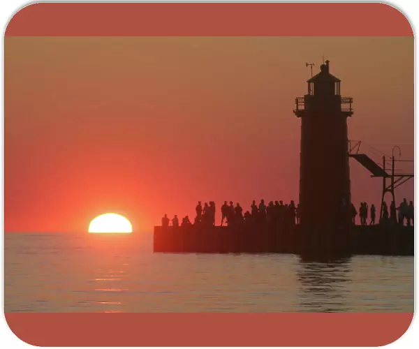 People lighthouse sunset silhouette at South Haven Michigan