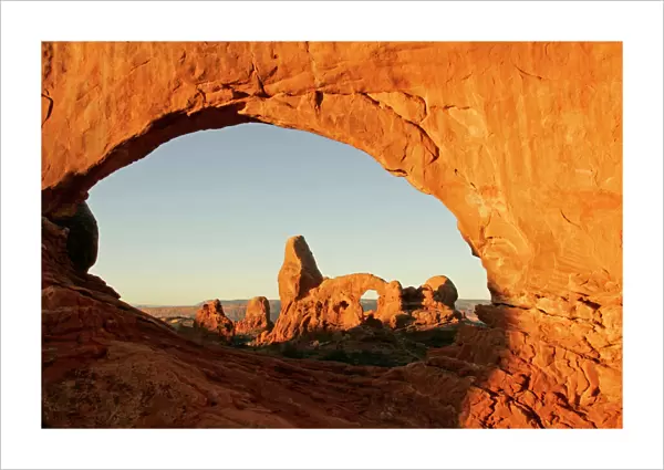 USA, Utah, Arches National Park. Turret arch seen through the North Window at sunrise