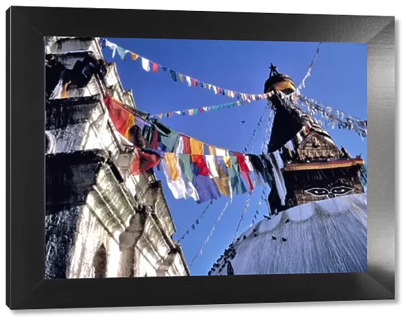 Asia, Nepal, Kathmandu Valley. Bright colored prayer flags flutter in the wind at