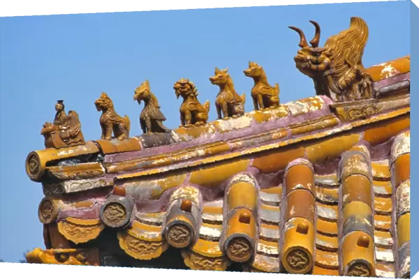 Asia, China, Beijing. Small dragon sculptures adorn the tile roofs of the Forbidden City
