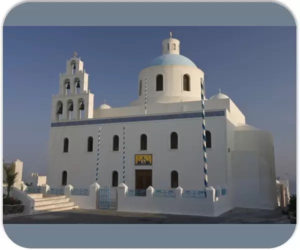 Greece, Santorini, Thira, Oia. Large Greek Orthodox church in main square with dome and bell tower