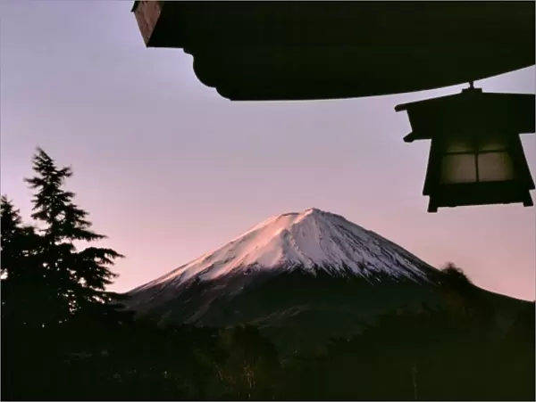 Japan, Honshu, Yamanashi Pref. Fuji-Hakone-Izu NP. Sunrise brings a subtle glow to Mt