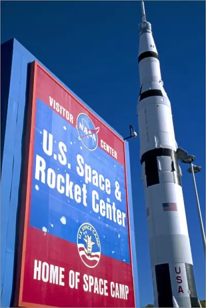 Saturn V mock-up stands next to the U. S. Space and Rocket Center sign located in Huntsville