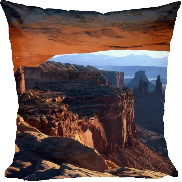 CANYONLANDS NATIONAL PARK, UTAH. USA. View through Mesa Arch at sunrise. Island in the Sky