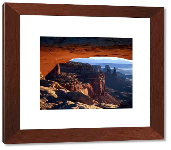 CANYONLANDS NATIONAL PARK, UTAH. USA. View through Mesa Arch at sunrise. Island in the Sky