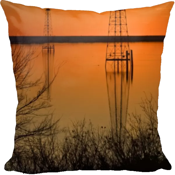 Oil well derricks in Lake Arrowhead near Wichita Falls, Texas, USA at sunset, winter