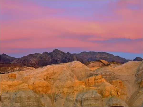 USA, California, Death Valley NP. Sunset colors the sky with vibrant pink and purple