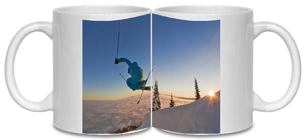 Skier catching air at sunset during an inversion at Whitefish Mountain Resort in Montana