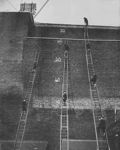 Firefighters climbing wheeled escape ladders