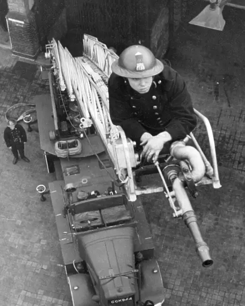 Blitz in London -- AFS firefighter on ladder, WW2