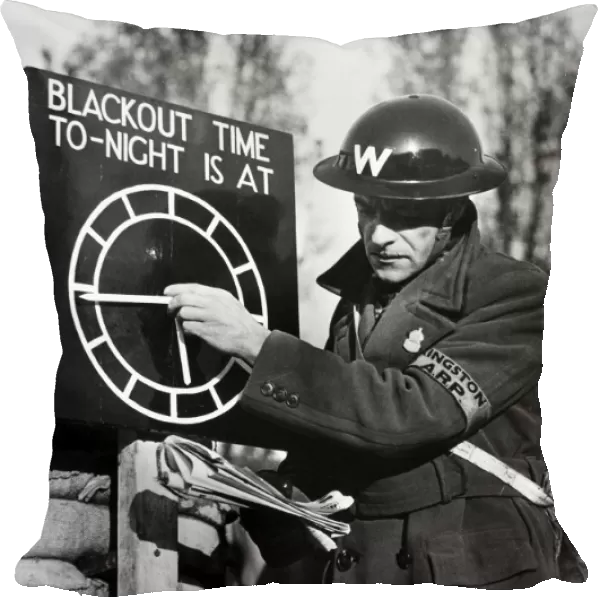 An air raid warden setting a blackout time clock indicator at an Air Raid Precautions post on the outskirts of London, England, following the outbreak of World War II, 1939
