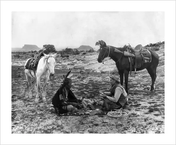 PLAYING CARDS, c1915. A cowboy and a Native American man seated on a blanket