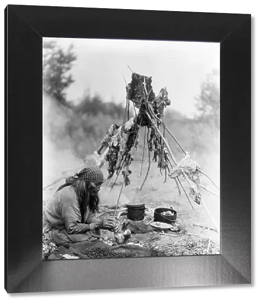 CURTIS: SARSI COOK, c1927. A Sarsi Native American in Alberta, Canada, preparing food